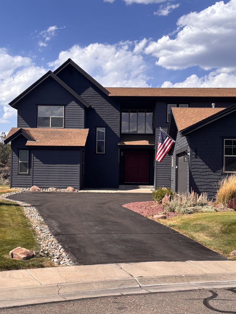 A finished asphalt driveway at a two story home in Gypsum, Colorado
