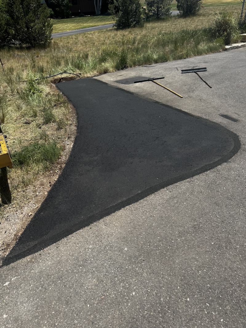 Summer patch work with the lute and screed still on the pavement